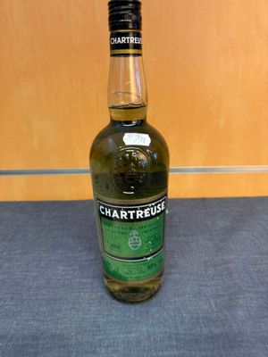 a bottle of chartreuse whisky sitting on a table