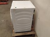 a white refrigerator sitting on a pallet in a warehouse