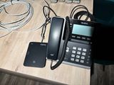 a phone and a cell phone sitting on a desk