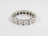 a close up of a diamond and white gold ring on a white surface
