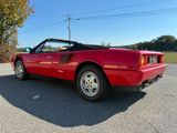 a red sports car that is parked in the parking lot