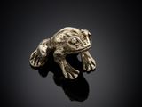 a close up of a frog figurine on a black surface