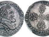 a silver coin with an image of a man on it
