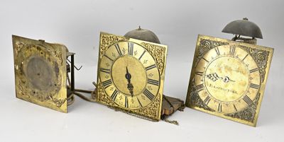 three clocks sitting next to each other on a table