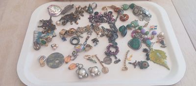 a tray with many different types of jewelry on it