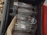 a basket full of empty soda bottles sitting on the floor