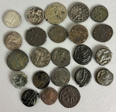 a close up of a pile of old coins on a white surface