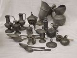 a lot of silver items that are on a white table