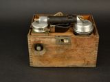a small wooden box with a small device inside of it