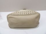 beige leather purse with crochet detail