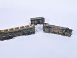 three toy trains that are sitting on a white surface