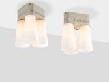 three light bathroom fixture with white glass shades on a gray wall