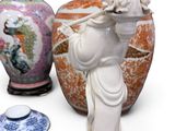 a statue of a woman holding a flute next to two vases and a plate
