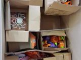 a cardboard box filled with halloween toys and other items