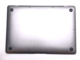 the back of a silver laptop computer sitting on top of a white surface