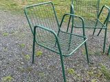 three chairs that are sitting in the gravel