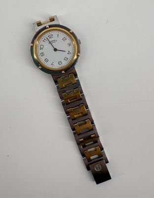 an image of a wrist watch on a white surface with a white background
