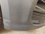 a close up of a car ' s front bumper and tire