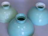 three blue vases that are sitting on a table