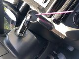 a car cup holder with a pink straw in it