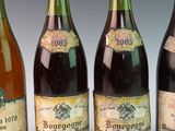 four bottles of wine are lined up in a row