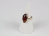 an image of a ring with a red stone on top of a white cone