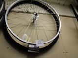 a bicycle wheel that is sitting on a shelf