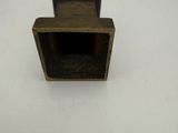 a small metal object on a white surface