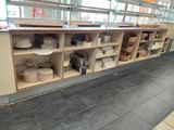 many shelves that have baskets on them in a store