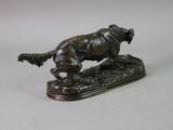 bronze statue of a dog running on a base on a white surface