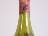 a bottle of wine that has a red cap on it