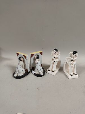 three figurines of a woman and a man on skis