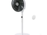 a fan that is sitting on a stand with a tennis ball in front of it