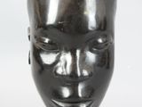 a sculpture of a woman ' s head on a table