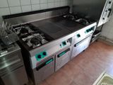a kitchen with a stove, oven, and sink in it