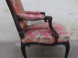 a red chair with a floral upholstered seat