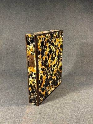 a close up of a leopard print book on a gray surface