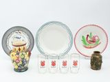 a lot of different plates and cups on the table