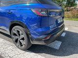 the rear end of a blue suv parked in a parking lot