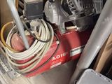 an image of a small air compressor in a garage