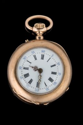 a gold pocket watch with roman numerals on the face