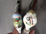 someone is holding a pair of wooden spoons with a picture of a deer on them