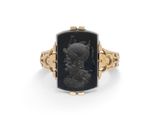 une bague en or avec une pierre noire au centre