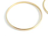 three gold rings on a white surface with a white background