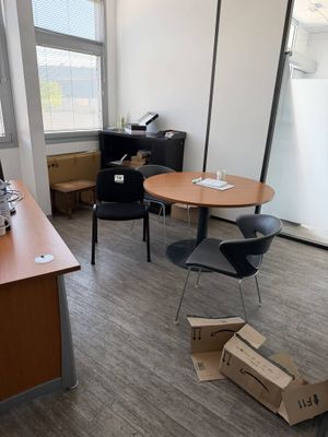 a room with a table, chairs, and a computer on it