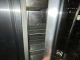 a man that is holding a metal object in front of an oven