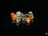 several different colored gems are arranged on a black surface