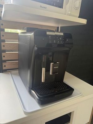 a coffee machine sitting on top of a white table