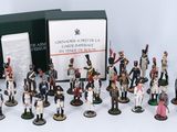 many figurines of different sizes and colors in a box