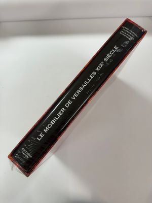 a close up of a tube of mascara on a white surface